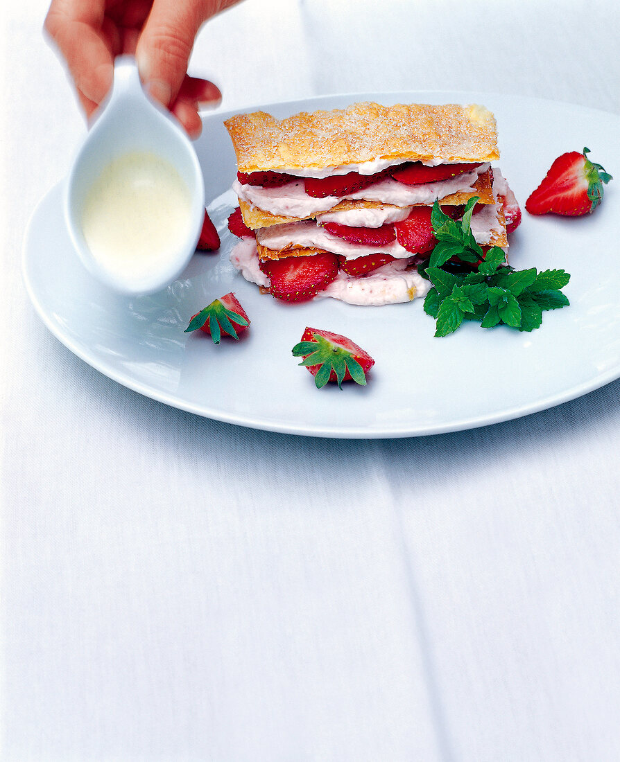 Strawberry mille-feuille with vanilla sauce on plate