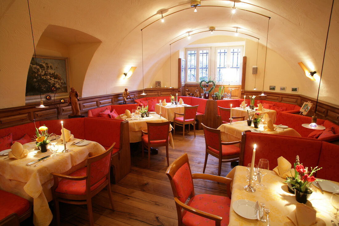 Interior of restaurant with illuminated dining tables, Germany