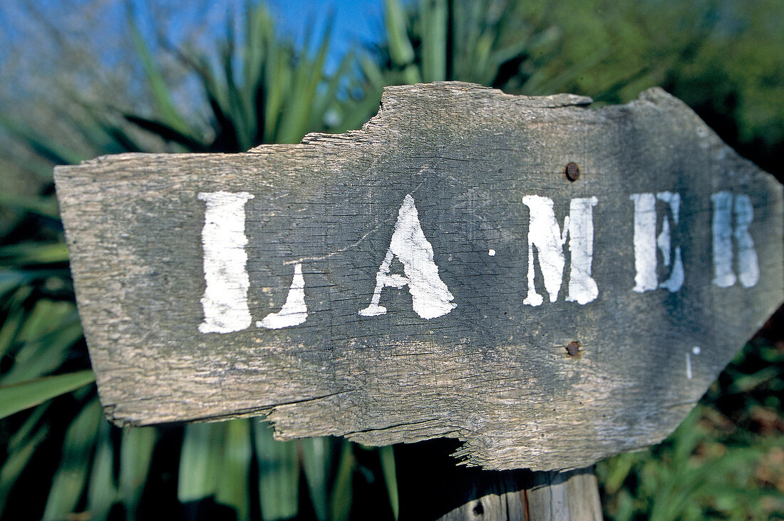 Wooden sign board with La Mer written on it at Cancale, Brittany, France