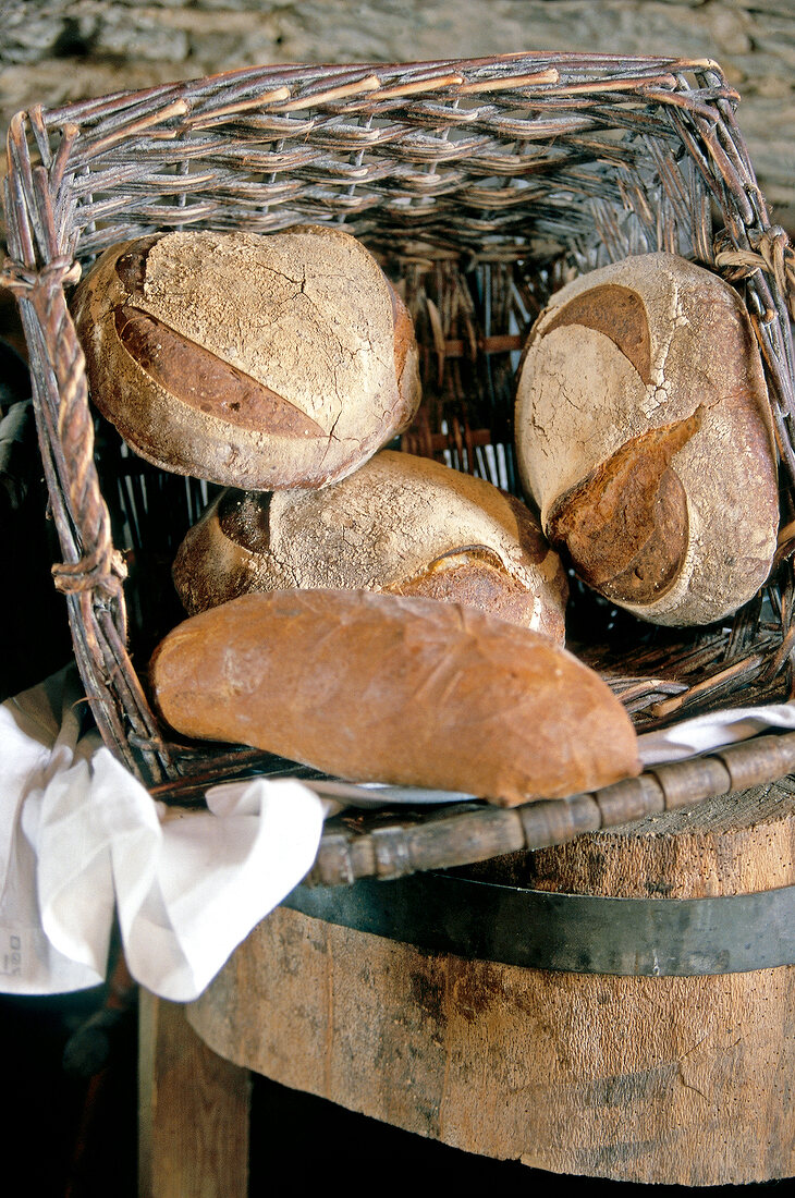 Several loaves of brown bread in wicker basket