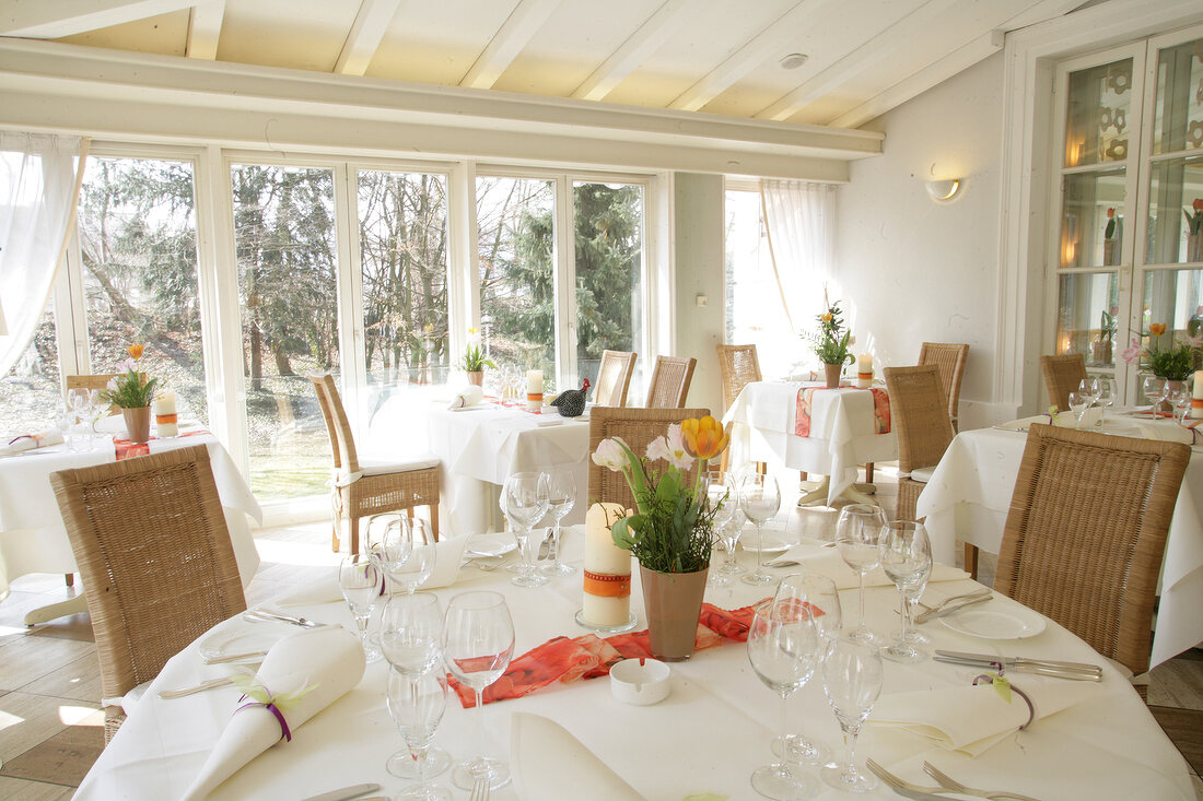 Interior of restaurant with laid tables and bar in Germany