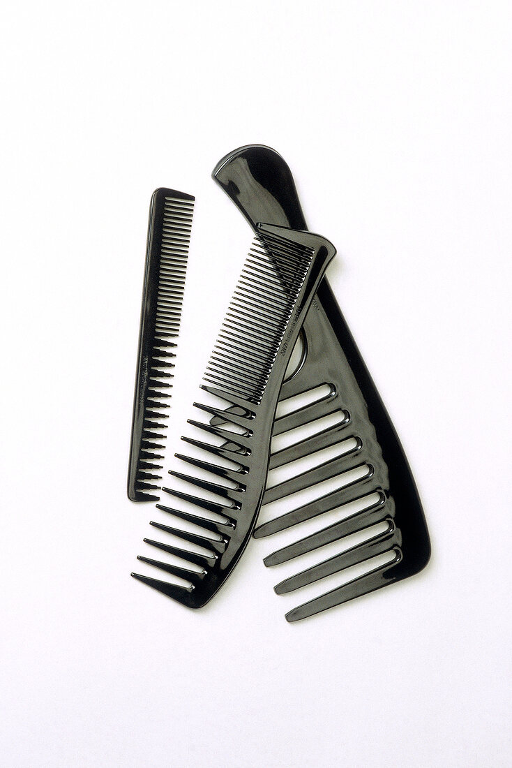 Three black combs on white background