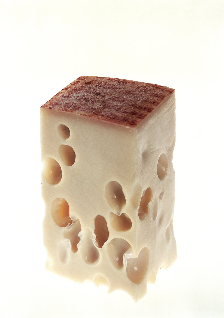 Block of emmental cheese on white background