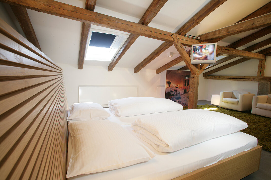 View of hotel's bedroom with wooden ceiling, Austria