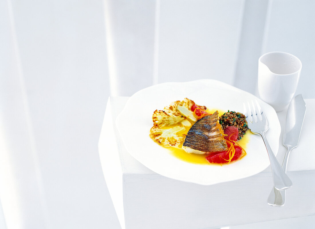 Marinated brook trout with green spell and caramelized cauliflower on plate