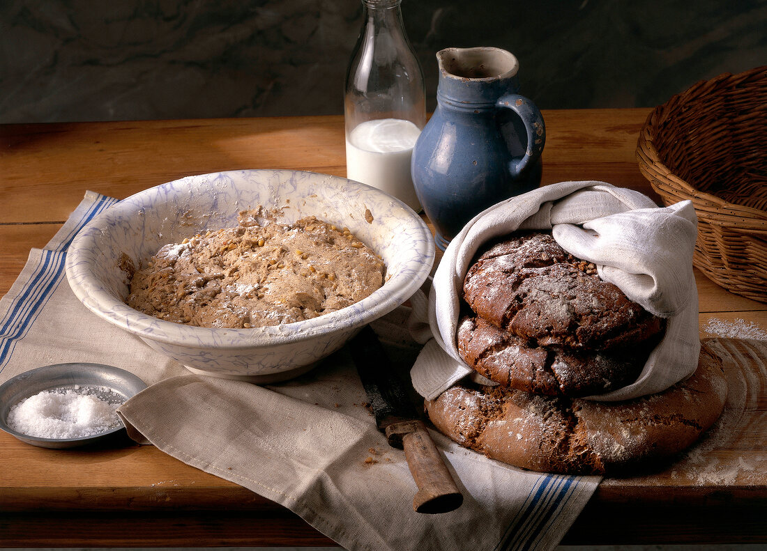 Loaves of tyrolean nut bread and dough in bowl