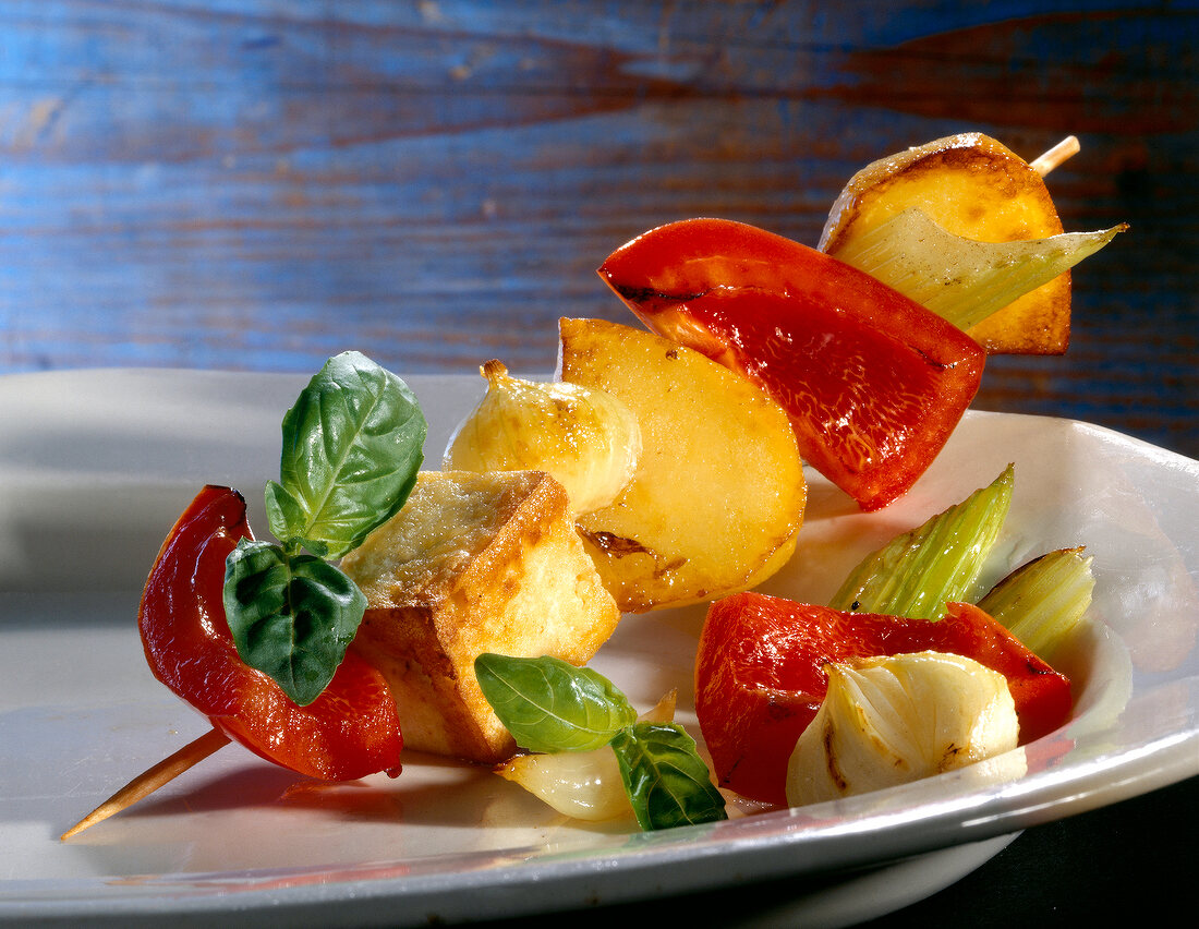 Skewered potato with basil, dipping sauce and smoked tofu