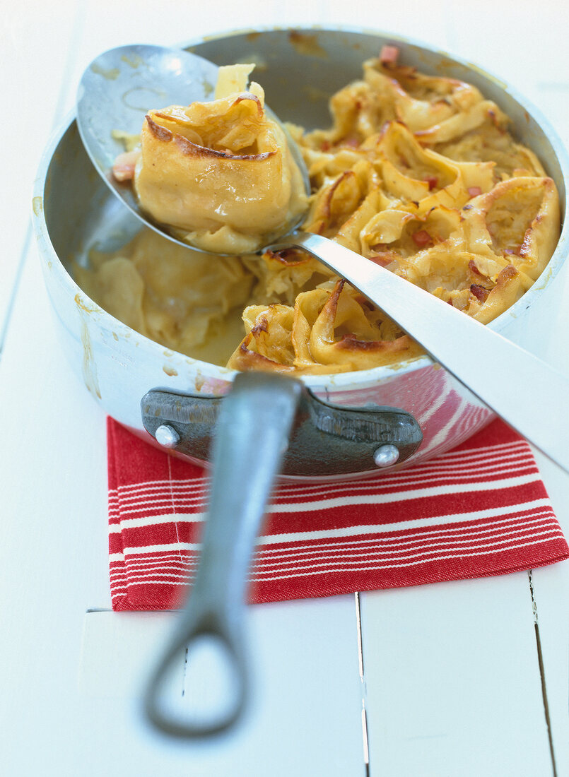 Krautkrapfen in spoon and sauce pan