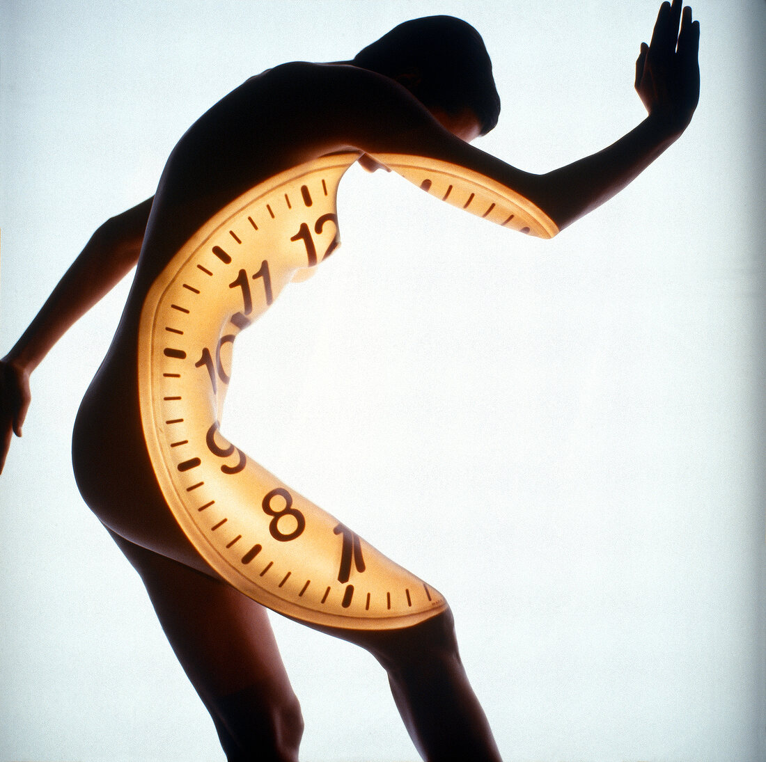 Nude woman with projector clock dial on her body, bending