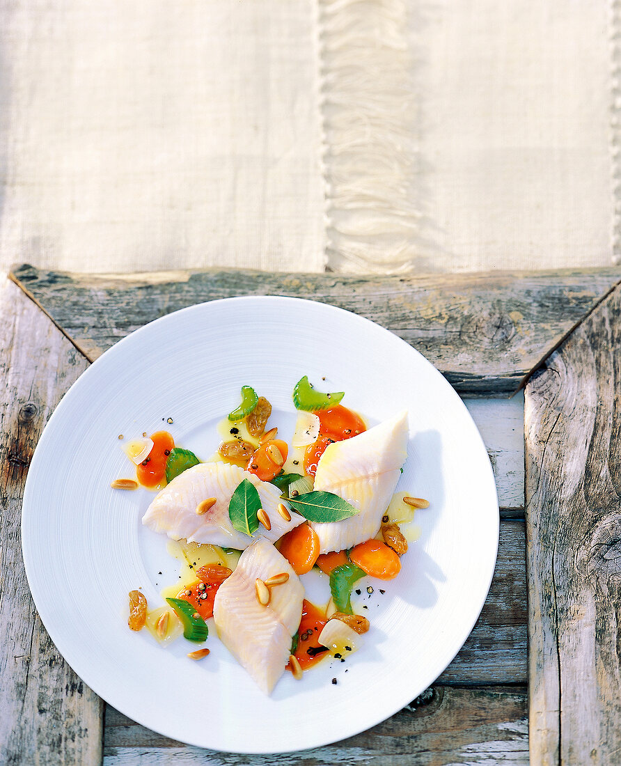 Venetian trout in saor with vegetables on plate