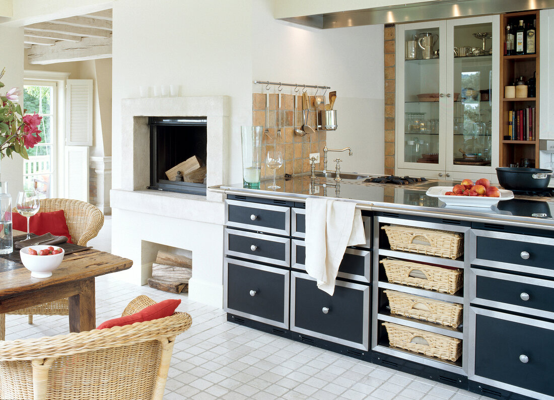 Open kitchen with wicker basket and fireplace