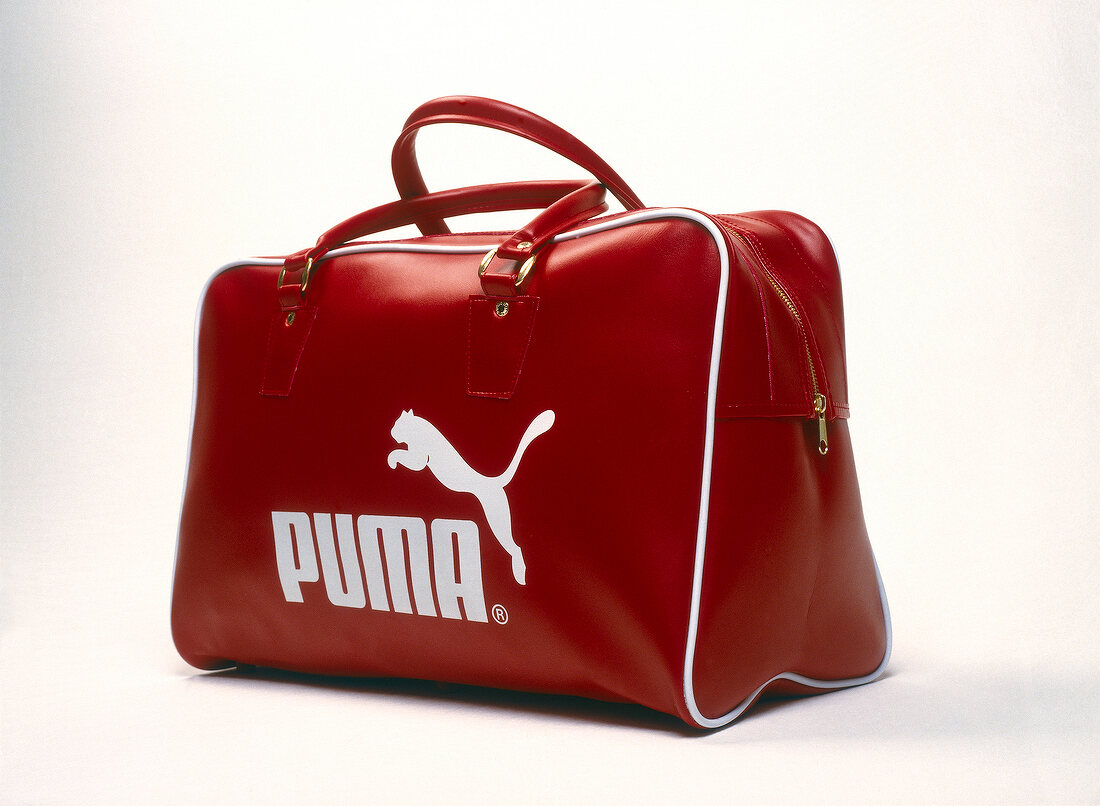 Red leather sports bag of Puma on white background