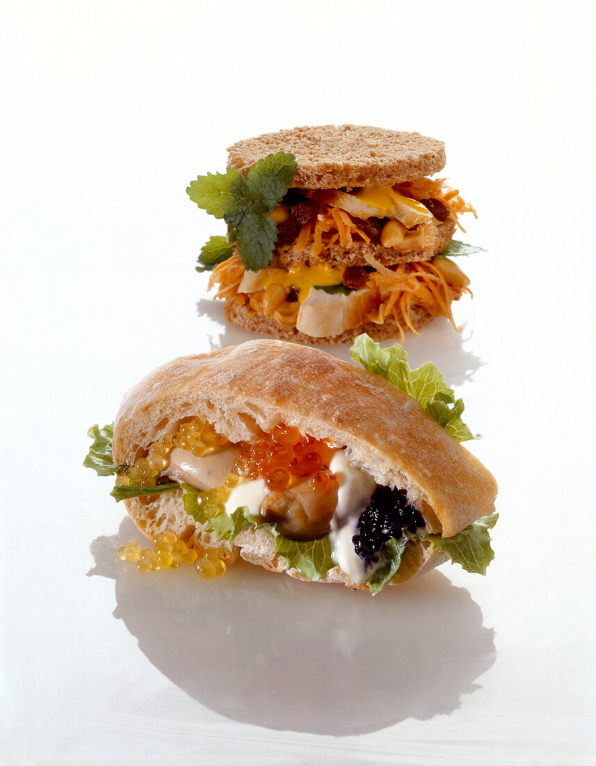 Two pieces of sandwiches with chicken breast, oysters and caviar
