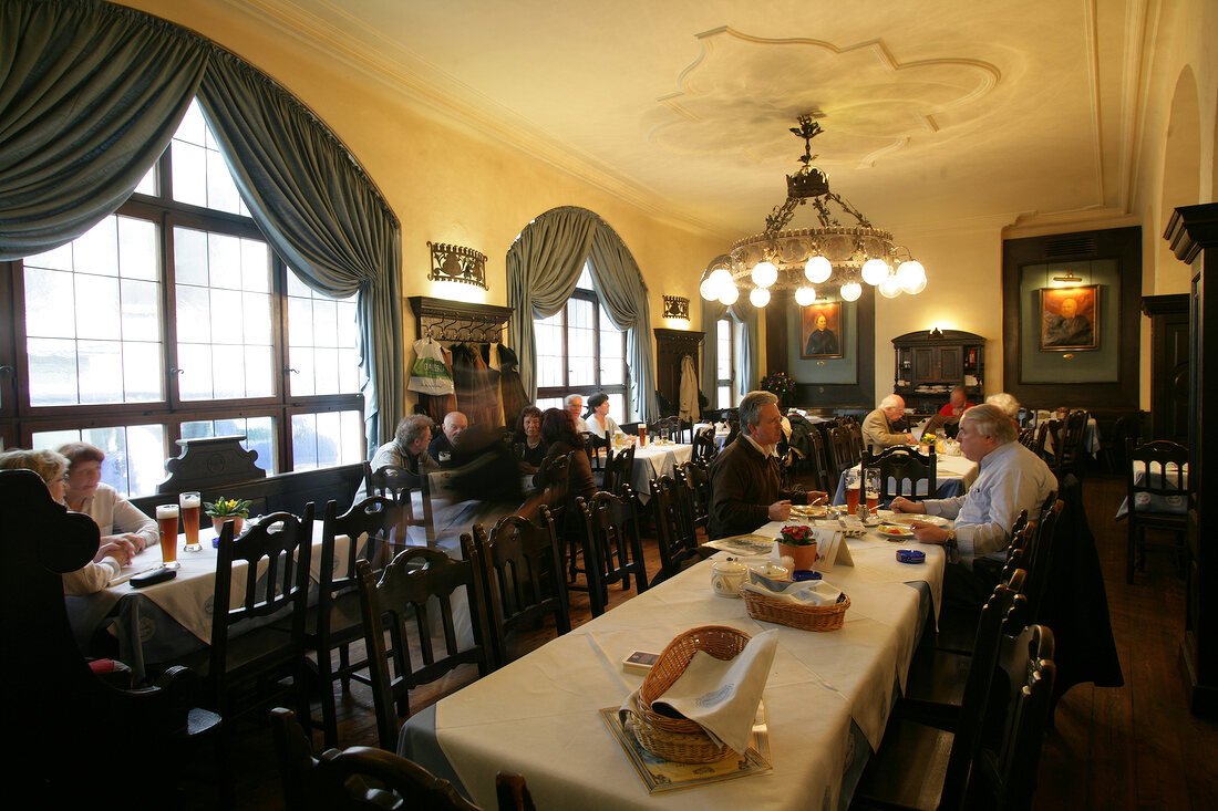 People sitting at table in restaurant, Germany