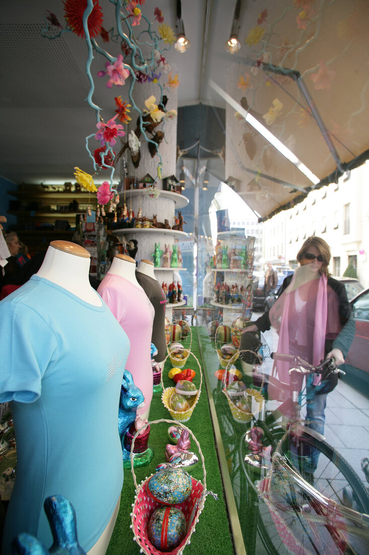 Mannequins at display in store decorated with fairy lights