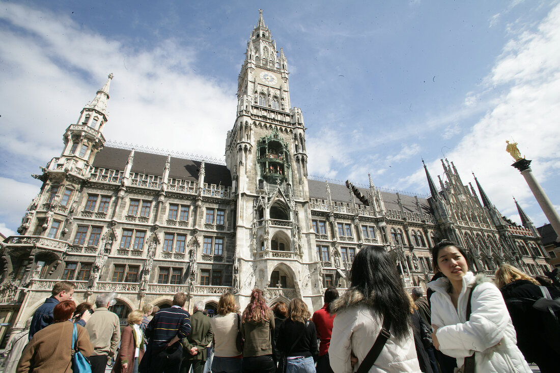 Low angle view of new city hall with people around, Marienplatz, Munich, Germany