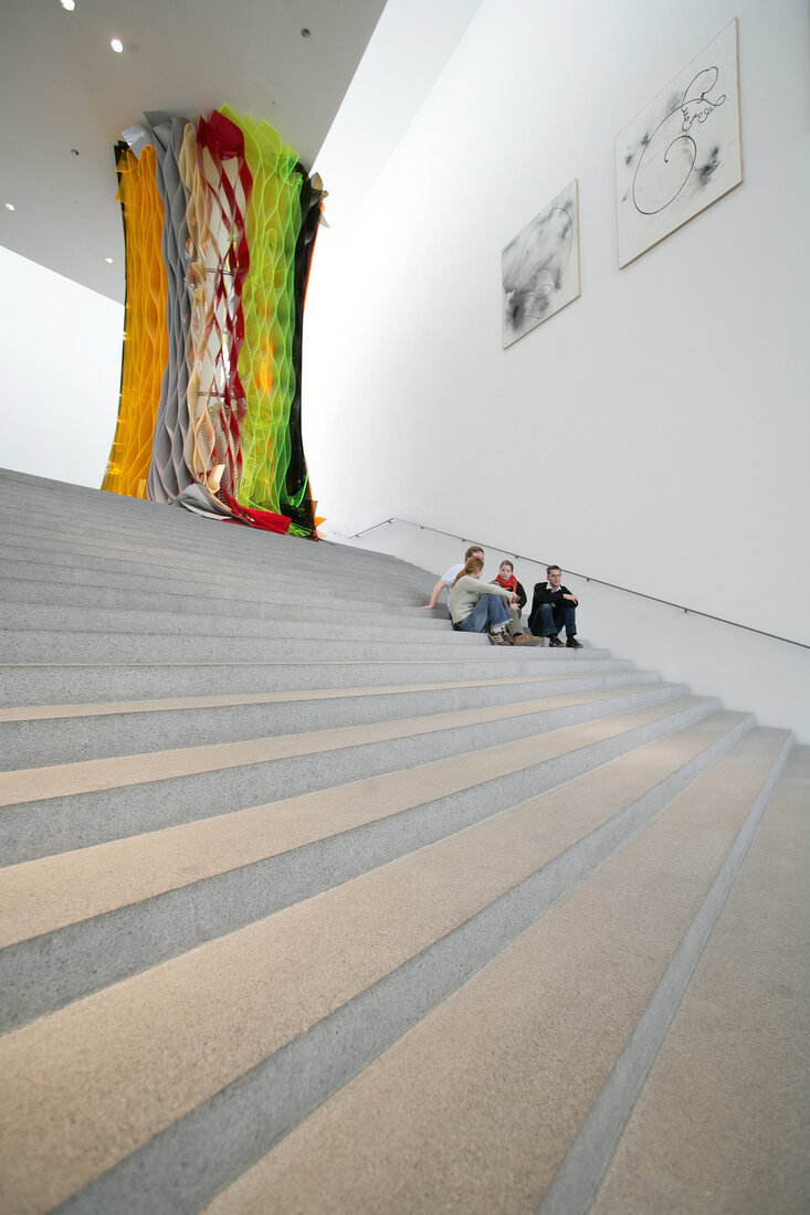 People sitting in Pinakothek der Moderne Museum in Munich, Germany