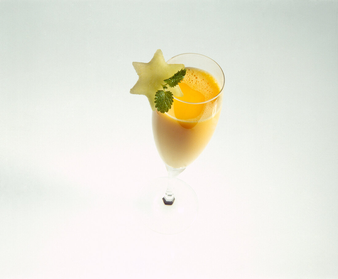 Snowball cocktail garnished with star shaped melon flesh