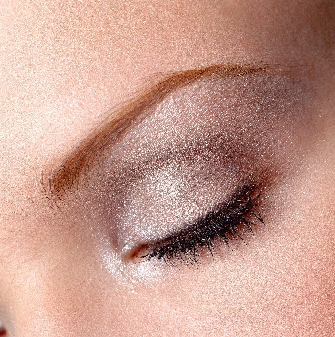 Close-up of woman's eye wearing silver eye shadow