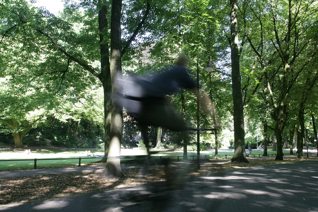 Rear view of woman cycling in park