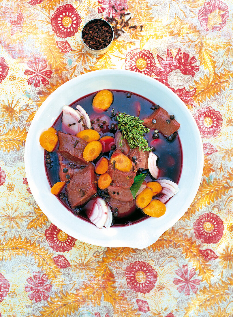 Venison with vegetables in red wine and marinade in bowl