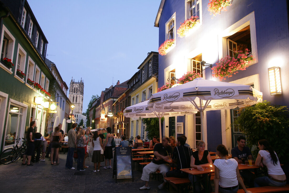 People sitting at table outside restaurant, Germany