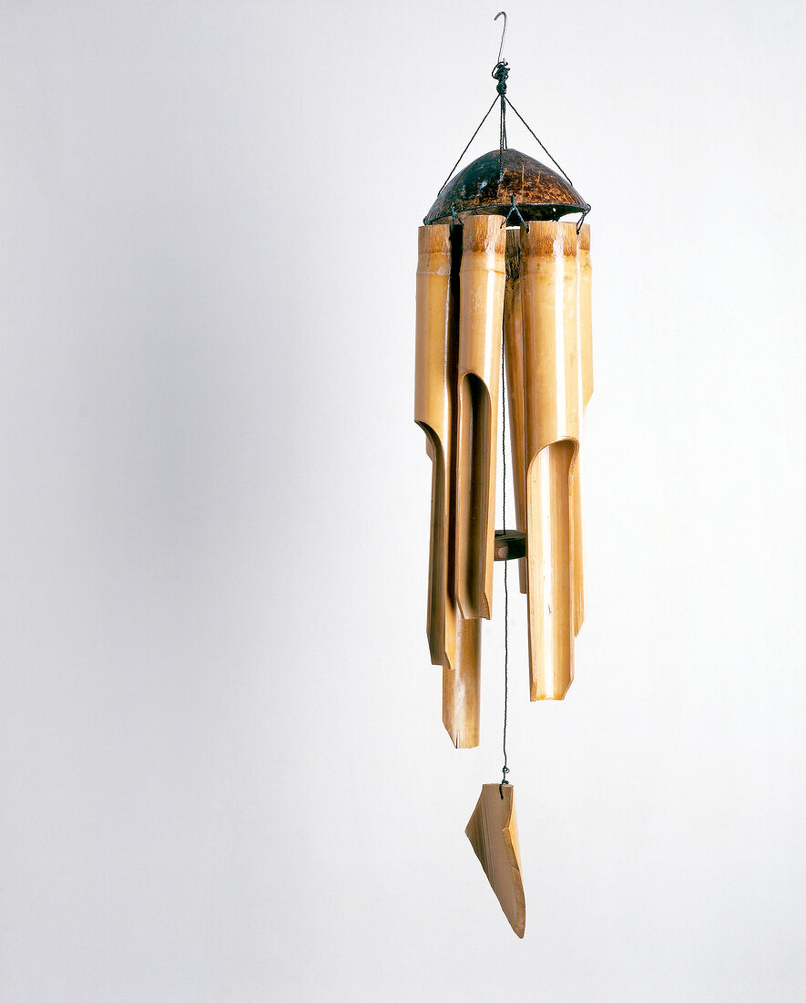 Wind chime made bamboo and coconut against white background