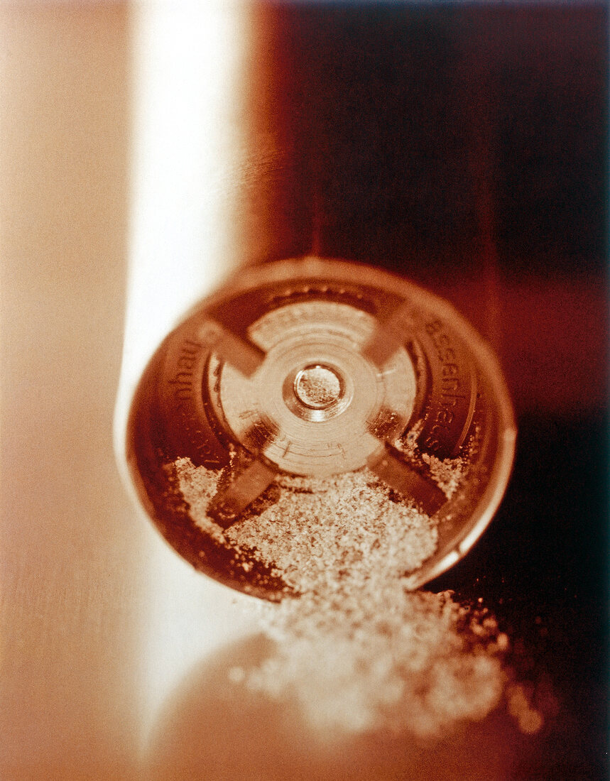 Close-up of ground pepper on pepper mills