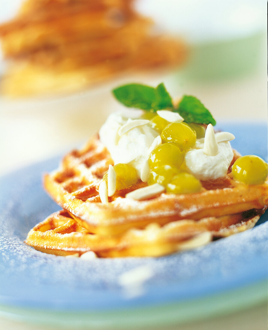 Close-up of waffles with green almond and grape jelly