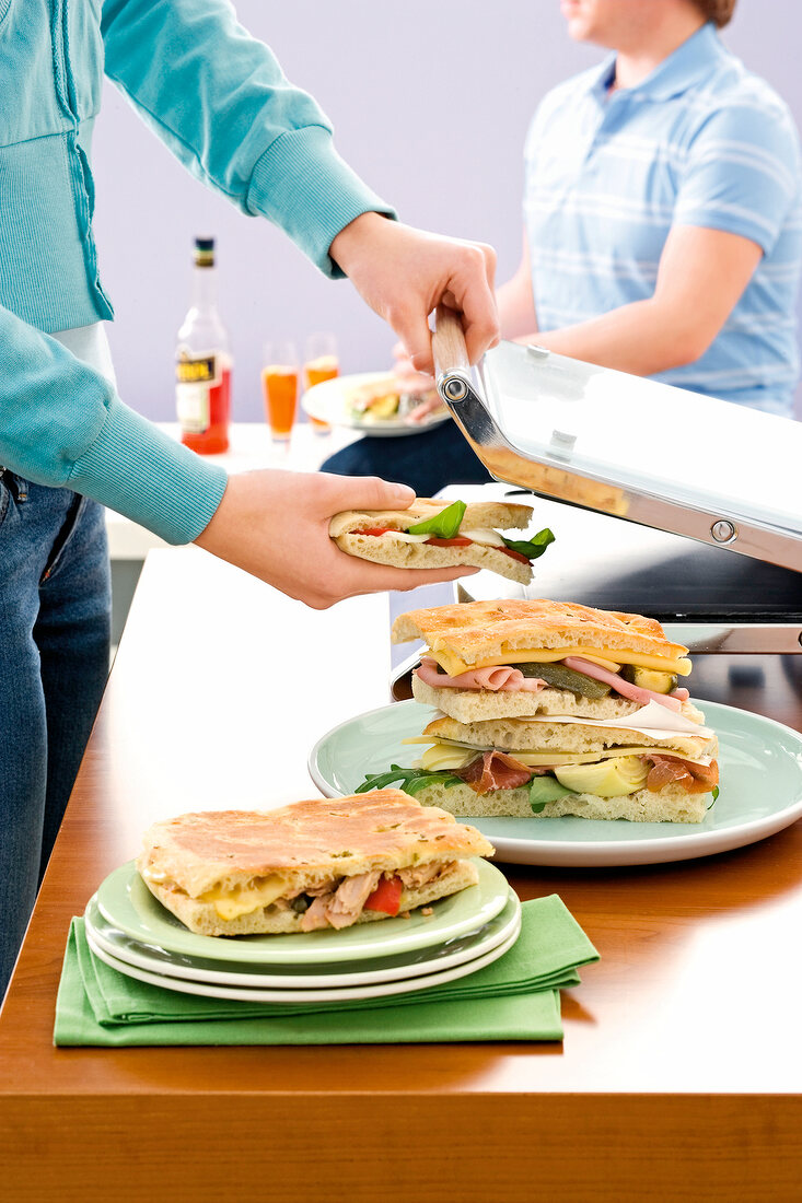 Close-up of woman making grill sandwich