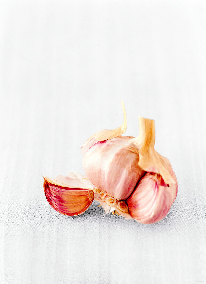 Close-up of garlic clove on white background