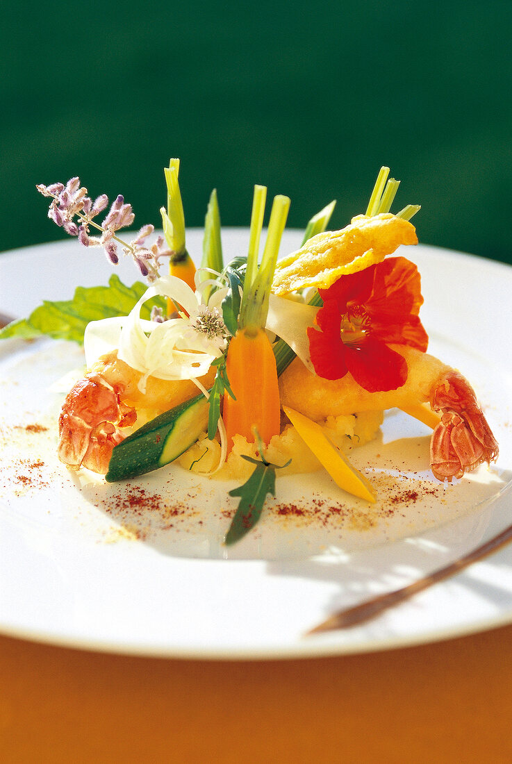 Langoustines with tempura, mashed potatoes and vegetables on serving plate