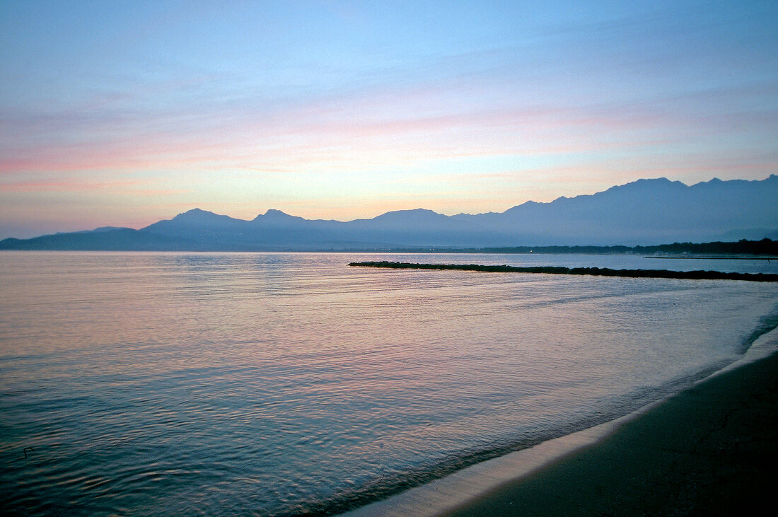 View of beach at dusk in Calvi, Corsica island, France