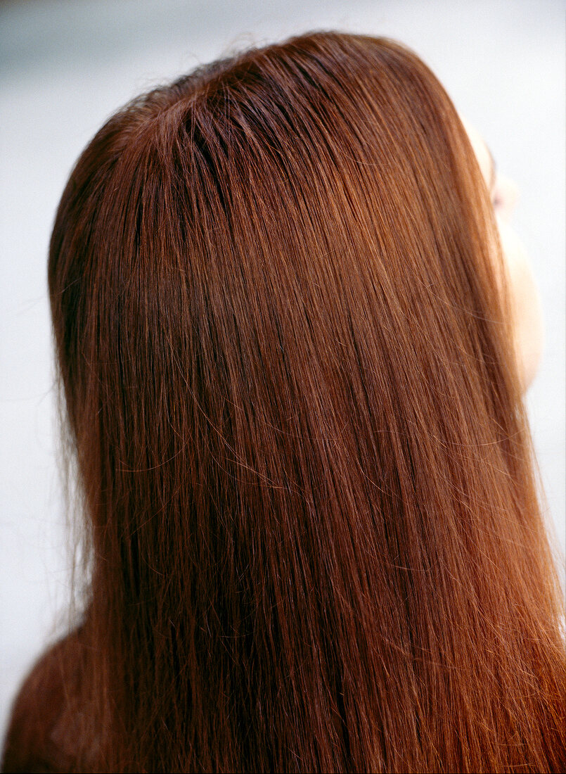 Rear view of red haired woman with long hair, close-up