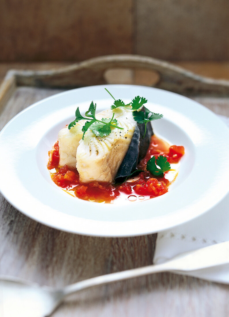 Halibut with tomato-ginger sud on plate