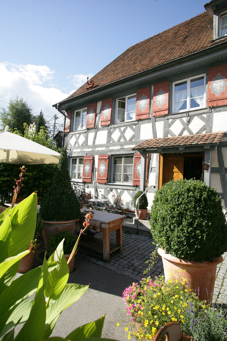 View of exterior of hotel with garden and potted plants, Germany