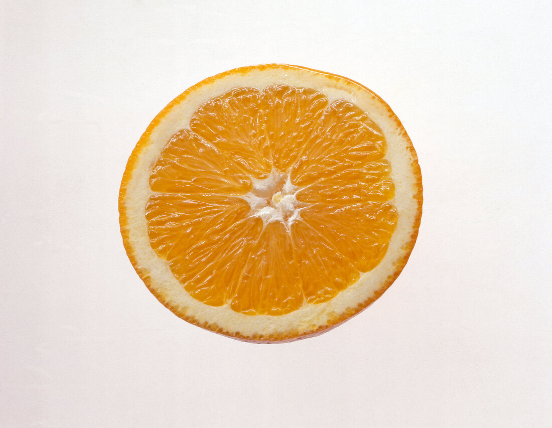 Orange slice on white background, overhead view