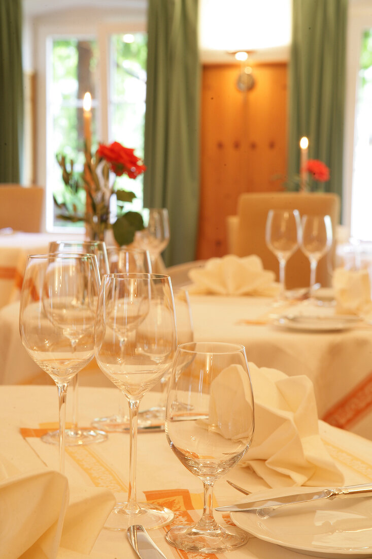 Close-up of glasses on laid table in restaurant, Germany