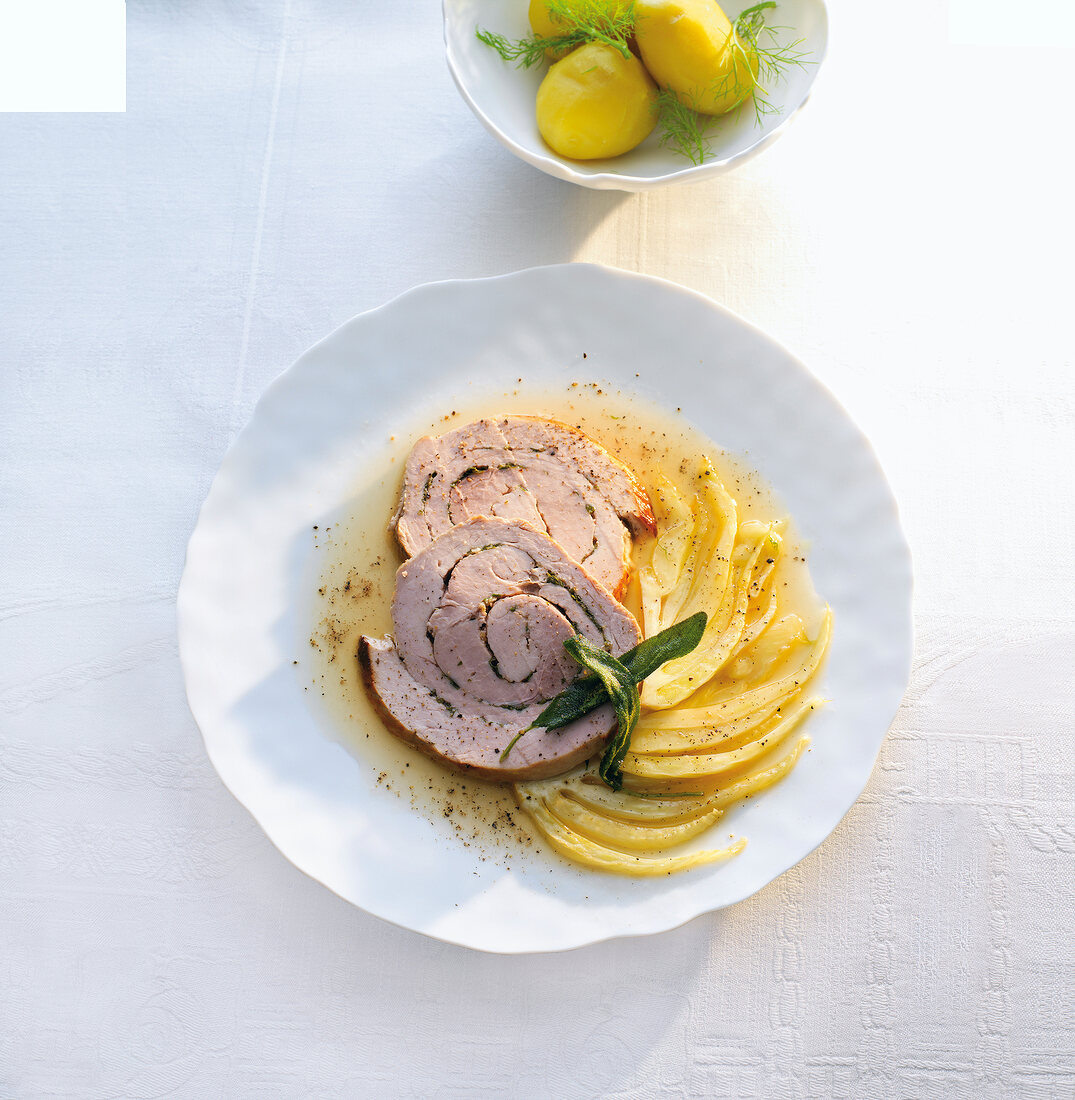 Rolled pork roast with fennel on plate