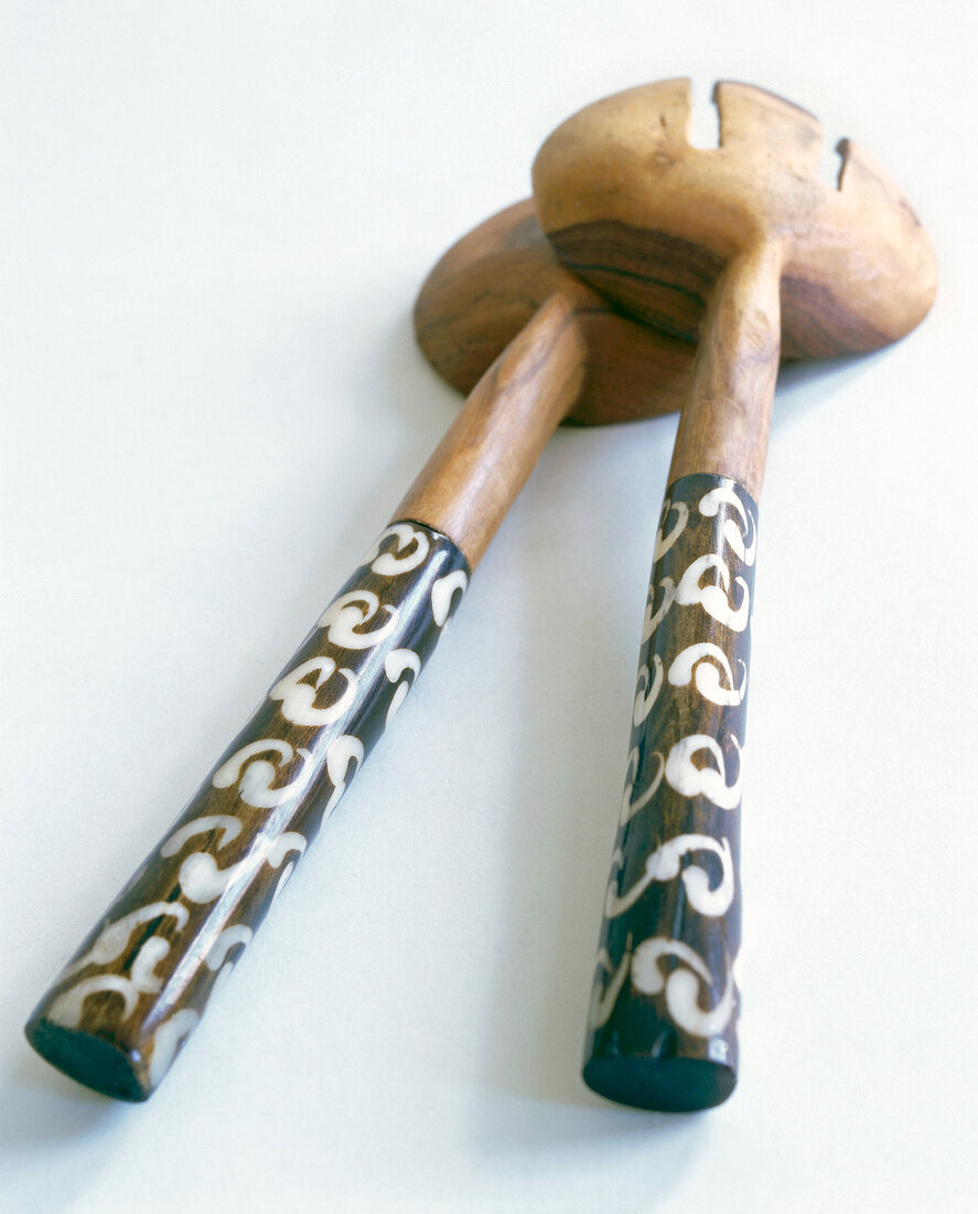 Salad servers with painted handle made from rosewood on white background