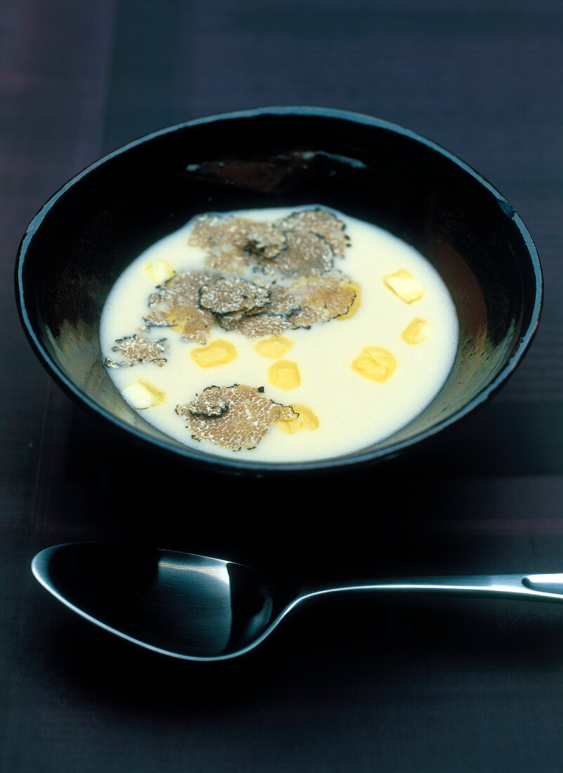Potato and celeriac soup with truffle in bowl