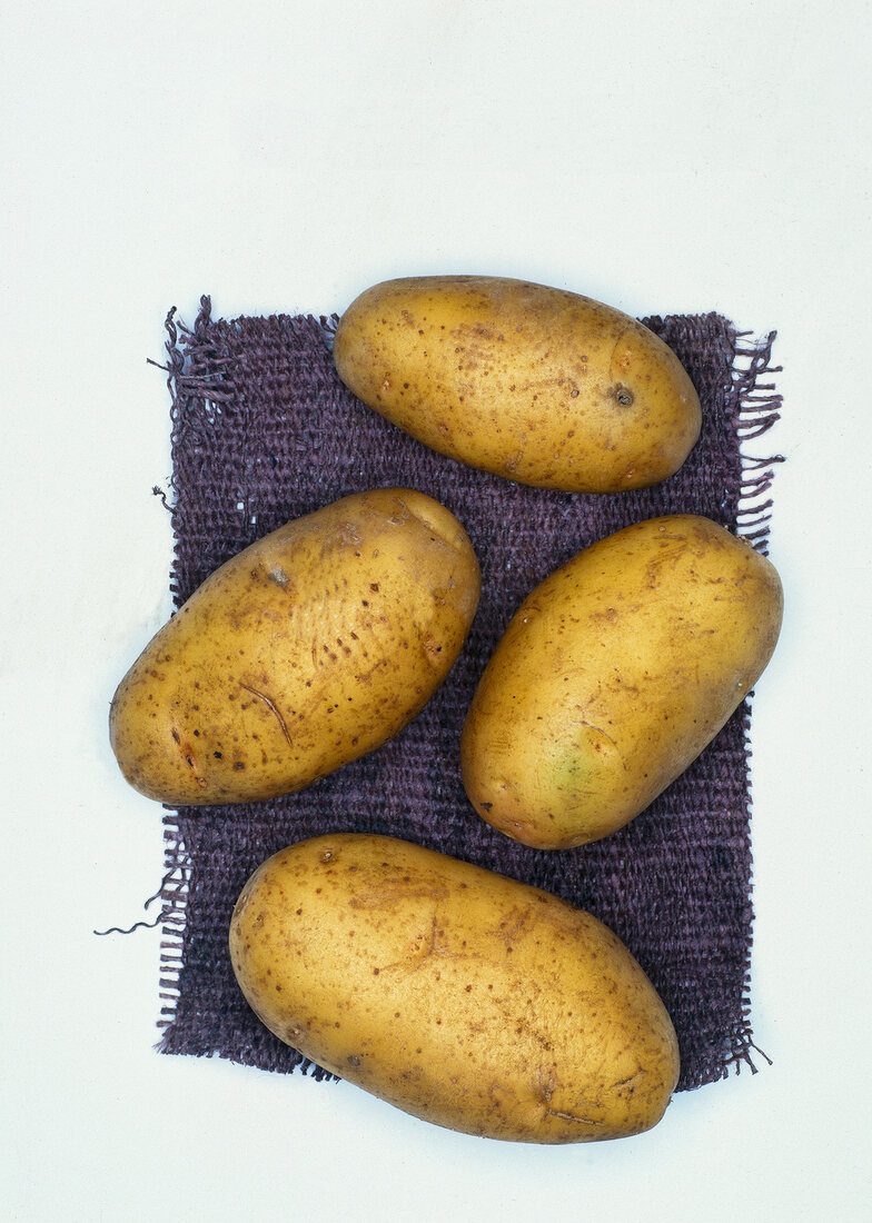 Nicola organic potatoes on white background