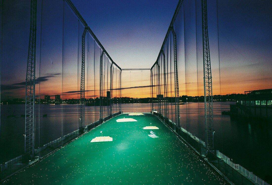 View of golf course on water overlooking skyline at dusk, New York, USA