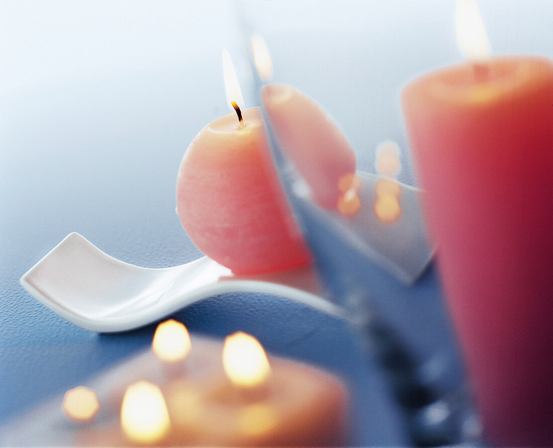 Lit pastel coloured candles