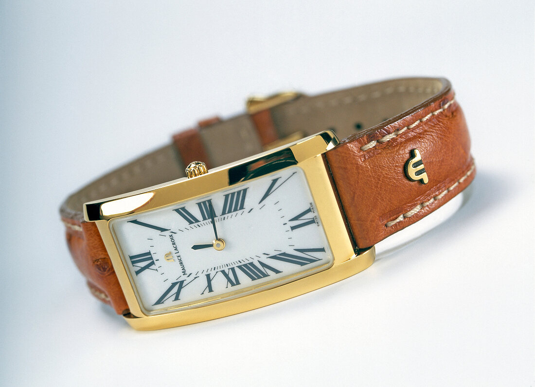 Close-up of wristwatch with leather strap on white background