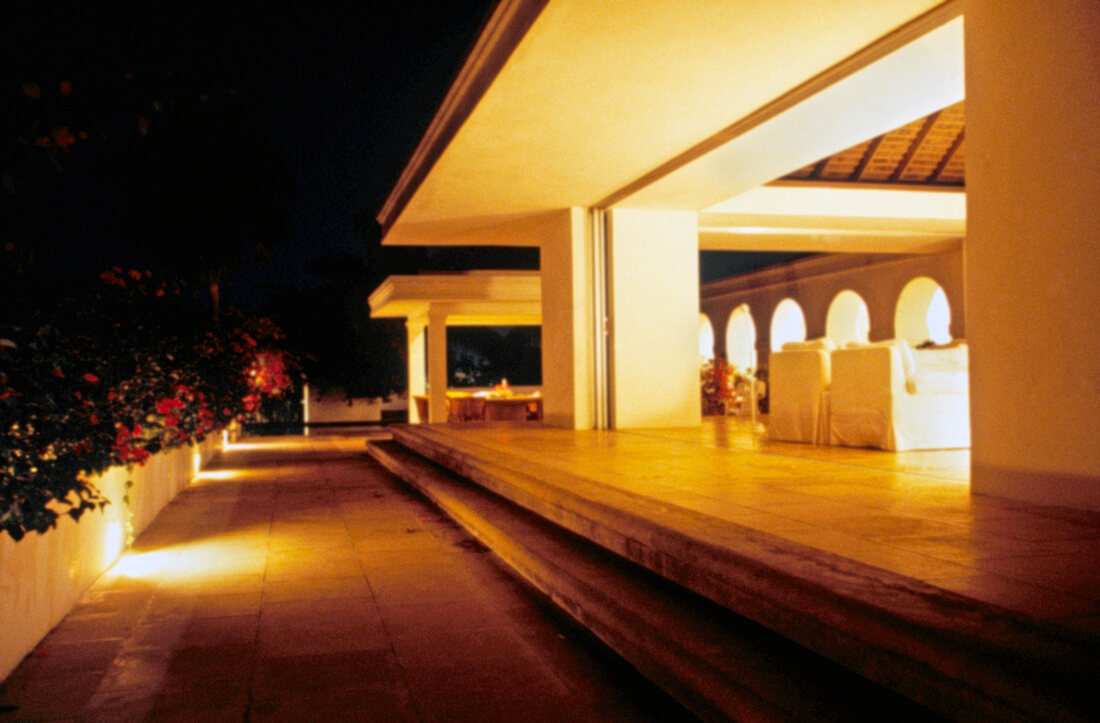 Brightly illuminated villa terraces and arcades in night, Jamaica