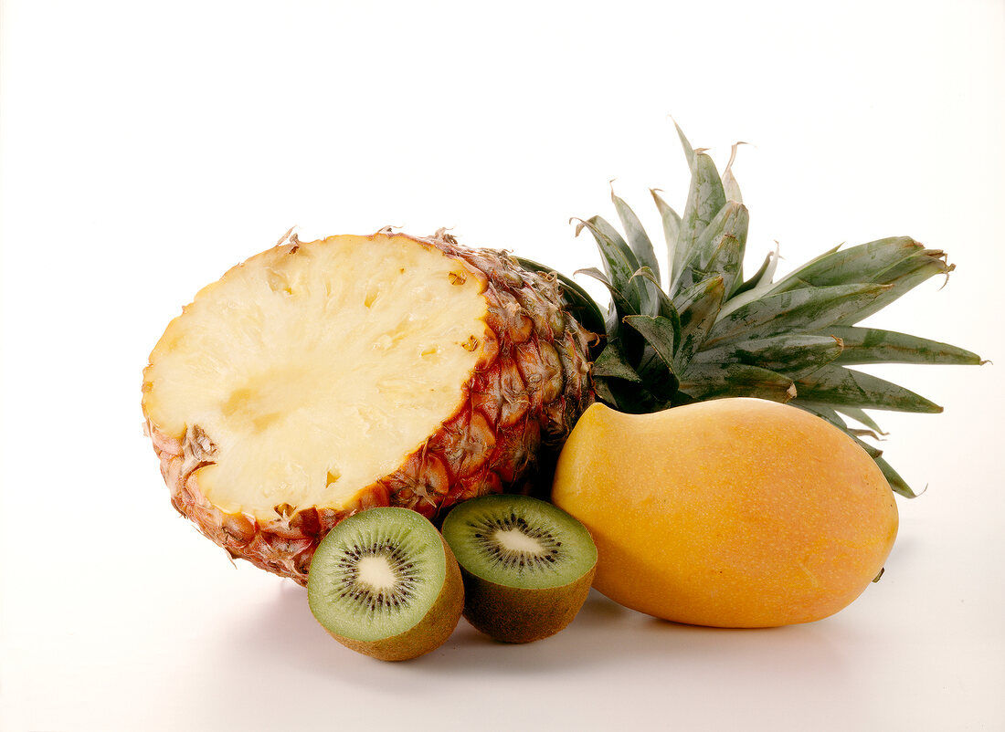 Capped pineapple, kiwi and mango on white background