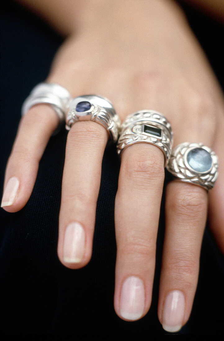 Close-up of woman's hand wearing big rings in fingers