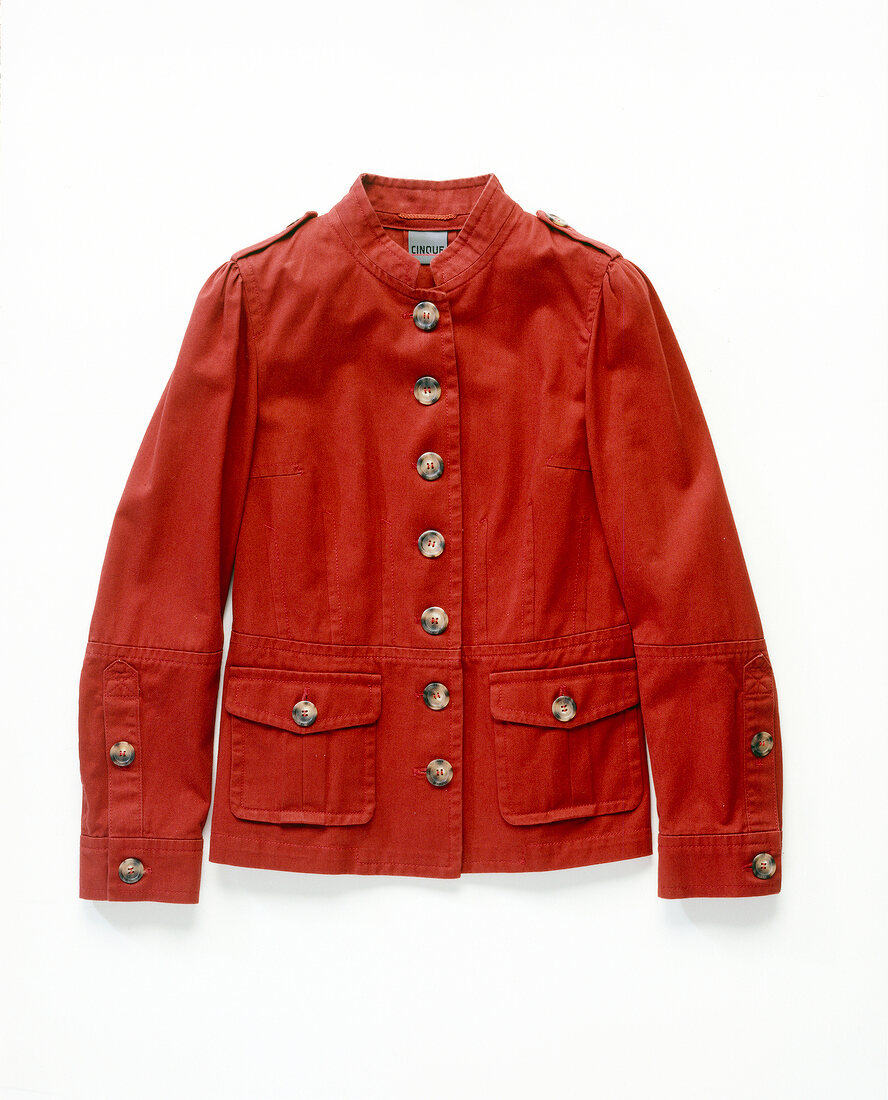 Close-up of red buttoned jacket on white background