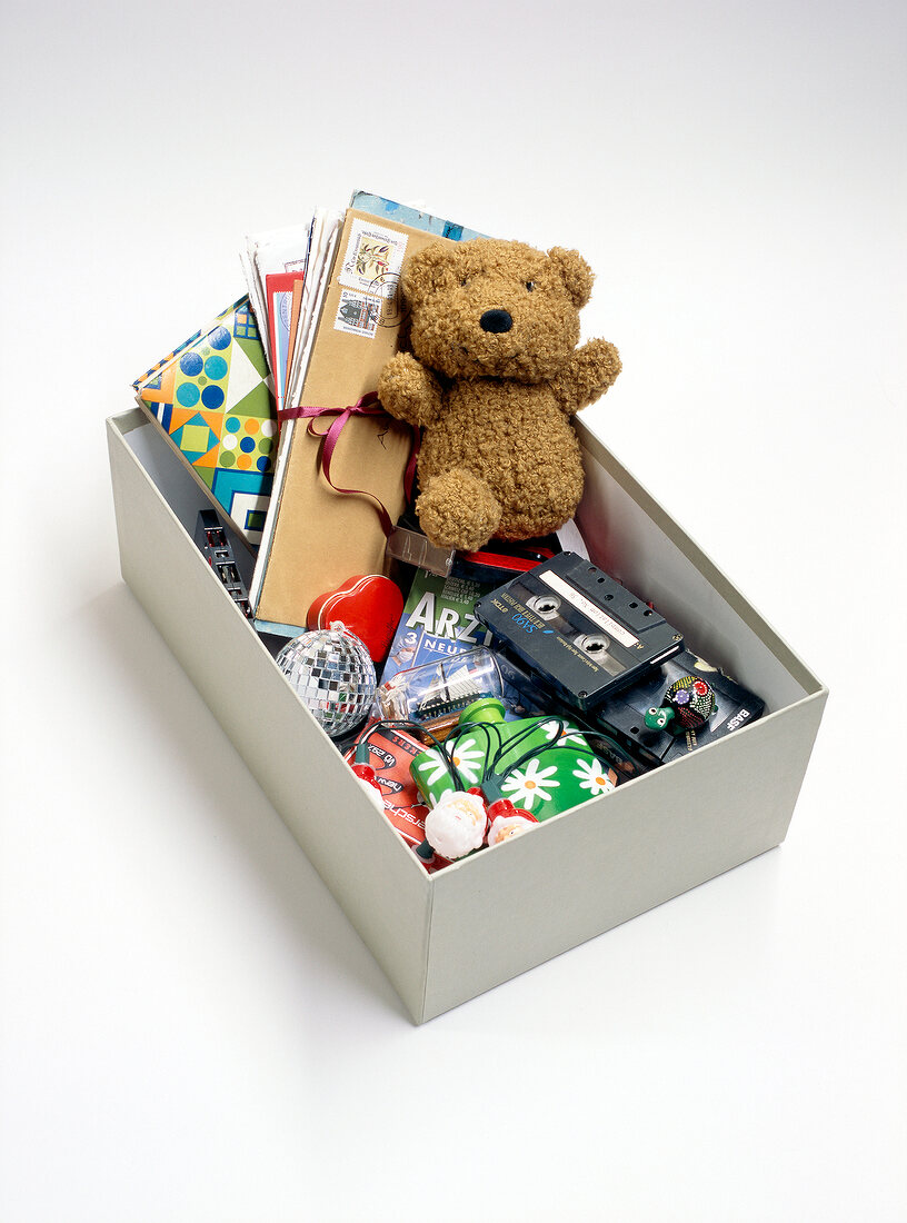 Shoebox with teddy bears, tapes and letters on white background